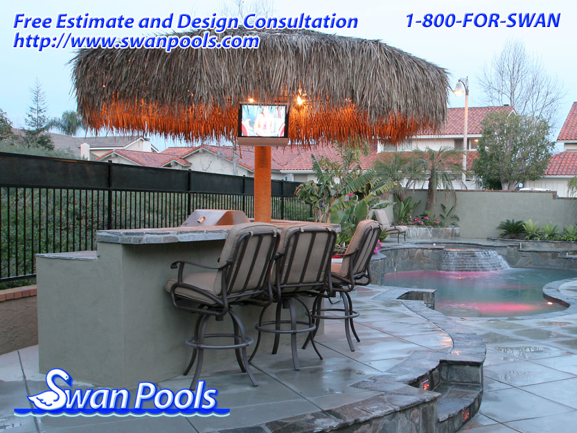 Custom arc barbeque with palapa, tile top, raised serving shelf, and stucco sides.