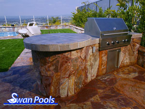 Small arc BBQ with tile top, stone sides, and a circular table top.  Click on image for a larger picture.