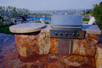 Small arc BBQ with tile top, stone sides, and a circular table top.  Click on image for a larger picture.