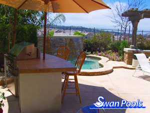 Small arc BBQ with tile top, stucco sides, a built in refridgerator, and serving shelf.  Click on image for a larger picture.