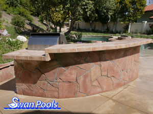 Small arc BBQ with tile top, raised serving shelf, and stone sides.  Click on image for a larger picture.