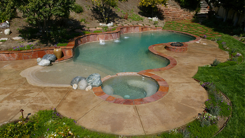 A desert oasis.  Swan Pools, a custom swimming pool builder, can create a relaxing and fun environment for those warm summer days.
