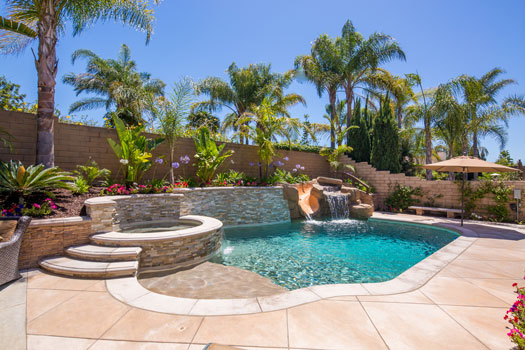 Geometric swimming pool and spa installed with fire bowls and a fire pit entertainment area in Newport Beach, California.