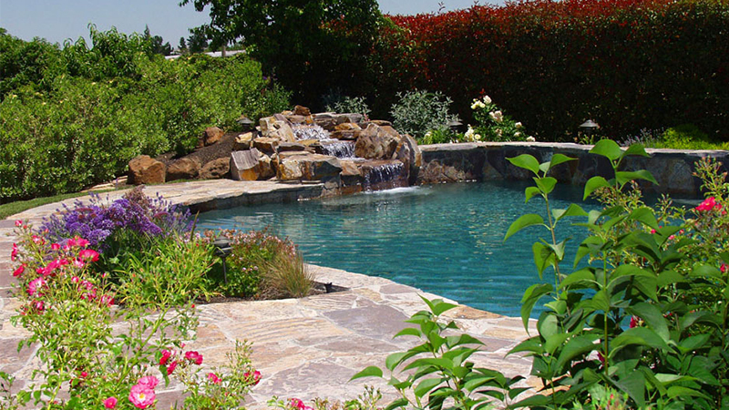 Here, we are inspired by the classic swimming hole. Sculpted with generous quantities of genuine Red Mountain river rock and surrounded by irrigated planters, this Stockton property has the look, the feel and the sound of a riverside hollow - a pool that Huck Finn might have designed.